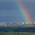 A strong rainbow seeming to emanate from the ?Hinkley C? construction site at Hinkley Point on the Bristol Channel coast, Somerset, England, UK.