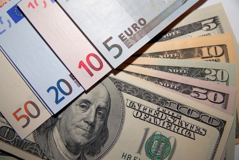 A stack of Euro and Dollar bank notes / currency / money / cash