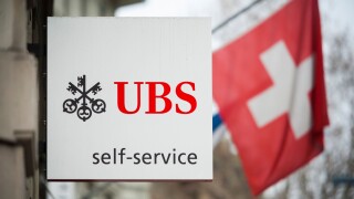 A "Self Service" sign is hanging outside an ATM branch of Switzerland's largest bank UBS in Zurich, Switzerland.