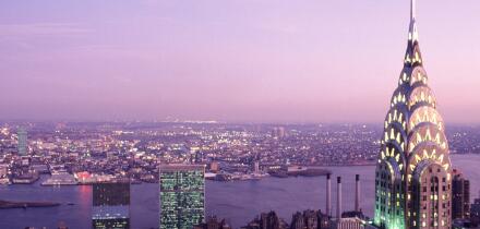 Chrysler Building illuminated evening sky. United Nations Building Commercial real estate The East River New York City skyline from above, Midtown USA