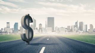 US dollar symbol on asphalt road-adobe-2022