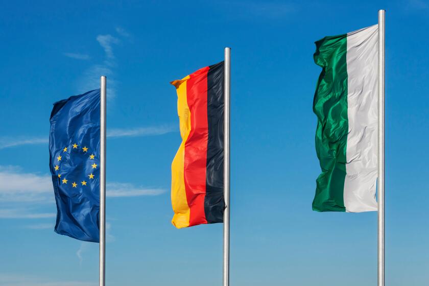 The flags of the Free State of Saxony, of Germany and of the European Union side by side