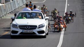 mercedes pace car followed by competitors in the ehc paracycling handcycling road race handbike playa blanca Lanzarote Canary Islands Spain