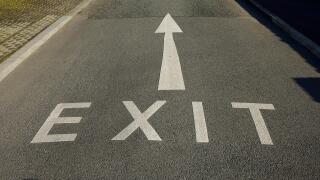 An Exit sign and arrow painted on a road in the UK