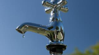 Fresh drinking water dripping and pouring from a tap