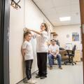 Medical professional measuring a child's height