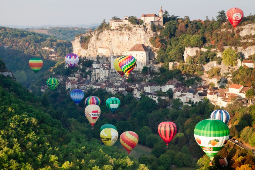 Hot air balloons rise just after dawn at Rocamadour, Midi-Pyrenees, France