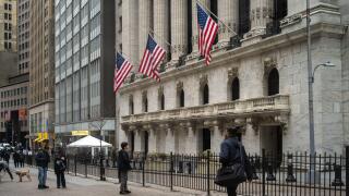 People walk past the New York Stock Exchange (NYSE) on Wall Street on March 4, 2026 in New York.