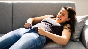 Woman Struggling With Tight Jeans. Weight Gain