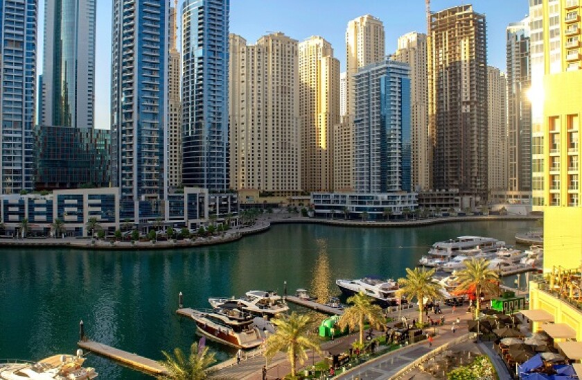 Dubai UAE - September 26, 2020: Beautiful view of Dubai Marina promenade and river from Marina Mall with many people before the sunset