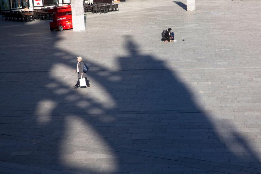 Coronavirus / Covid 19 outbreak, March 24th. 2020. Only few people on the square in front of Cologne central station, shadow of the cathedral, Germany