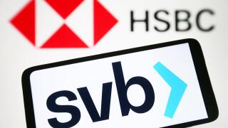 In this photo illustration, Silicon Valley Bank (SVB) logo is seen on a smartphone and HSBC UK Bank plc logo on a pc screen.