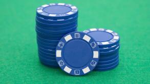 lots of blue poker chips on casino table