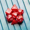 Lots of simple red RPG game dice, polyhedral dice set for role playing games and scenarios, top view. Dices group closeup. Tabletop board games