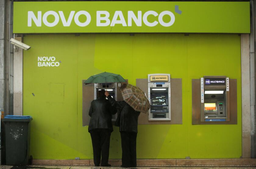 People use ATM machines at a Novo Banco branch in downtown Lisbon, Portugal, May 11, 2016. REUTERS/Rafael Marchante