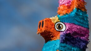 A close up shot of the head of a festive pinata.