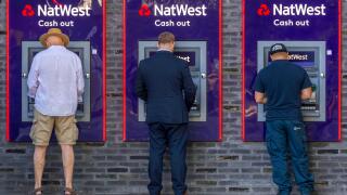 Men at the cash dispenser of NatWest Bank, London, Great Britain