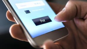 Mobile payment with wallet app and wireless nfc technology. Man paying and shopping with smartphone application and credit card information.