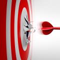 Setting New Goals and Breaking through or overcoming challenges as a dart representing entrepreneurship and unlimited business success focus blasting