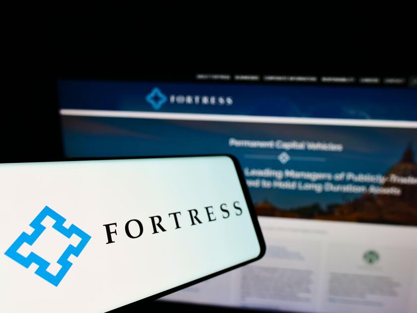 Smartphone with logo of American company Fortress Investment Group LLC on screen in front of business website. Focus on left of phone display.