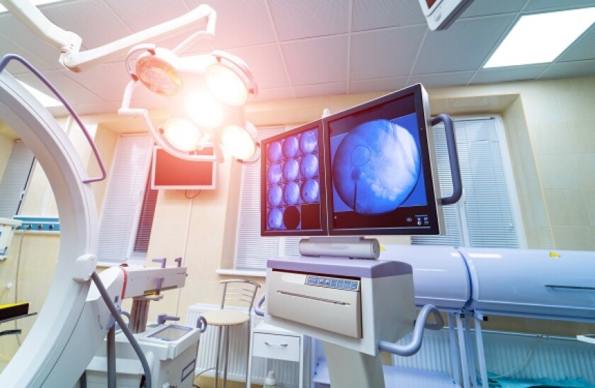 operating room with X-ray medical scan. real modern operating theater with working equipment, lights and computers.