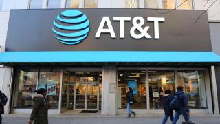 AT&T Store, 476-478 Fulton St, Brooklyn, NY. the gigantic logo of a telecommunications company and cellphone shop overlook shoppers on the Fulton Mall