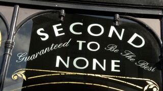 ' Second to None Guaranteed to be the Best ' sign on shop window