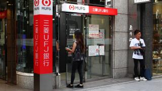 A customer entering a Ginza branch of the bank Tokyo-Mitsubishi UFJ in Tokyo. (6/2018)