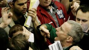 Traders shout in the Eurodollar options trading pit Wednesday, Jan. 30, 2008, at the Chicago Mercantile Exchange. Wall Street surged higher Wednesday after the Federal Reserve, confirming that there is increasing stress on the economy, cut interest rates 