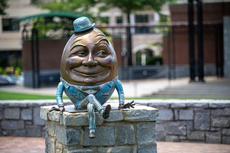 Humpty Dumpty statue sitting on wall in Suwanee Town Square, Suwanee, Georgia