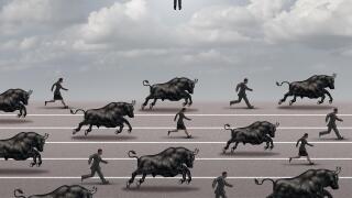 Escape the bull market and investing timing concept as an investment strategy symbol as bulls and shareholders running in an economic crisis.