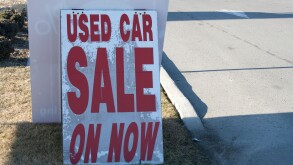 used car on sale now sign dealership dealer enter road market pavement road