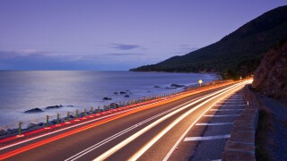 Car light trails on coastal highway.  Captain Cook Highway between Port Douglas and Cairns, Queensland, Australia