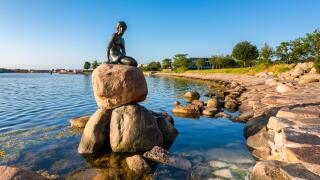 The famous Little Mermaid statue in the harbor of  Copenhagen Denmark