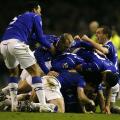 Everton players pile on top of goalscorer Dan Gosling after he scores his sides first goal of the game