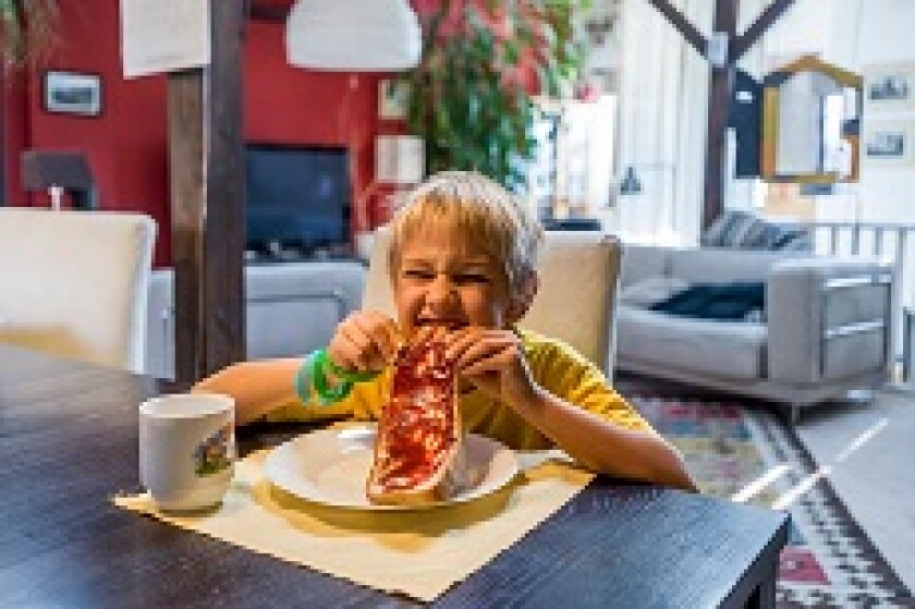 Kid_sinking_teeth_into_bread_alamy_230x153