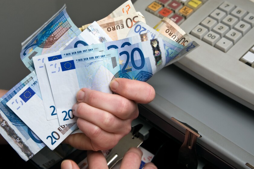 Berlin, Germany, money is taken out of the cash register