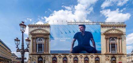 Advertising billboard for the Beckham - Boss clothing collection, by Hugo Boss, over the restoration works on the main facade of the Paris Opera house