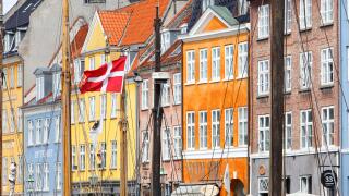 Copenhagen, Denmark - September 4, 2019: Dansh flag in one of the ships masts in the Nyhavn harbor area.