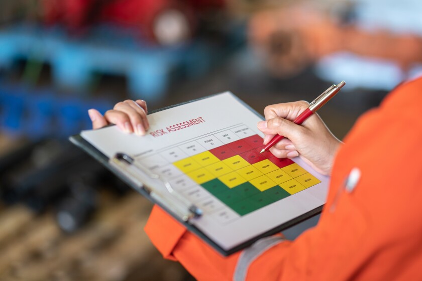 Action of a person is using ballpoint pen to marking on the risk