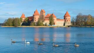 Medieval castle of Trakai, Vilnius, Lithuania, Eastern Europe, located between beautiful lakes and nature with family of swans