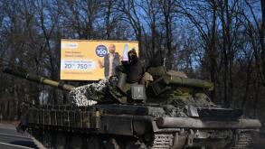 A Ukrainian tank crew member waves at the camera as Ukrainian tanks heads North on a highway in Chuhuiv. Following the beginning of Russian military action overnight. Chuhuiv, Ukraine, February 24, 2022. (Photo by Justin Yau/Sipa USA)