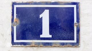 Number 1 (one) in white on a blue metal plate