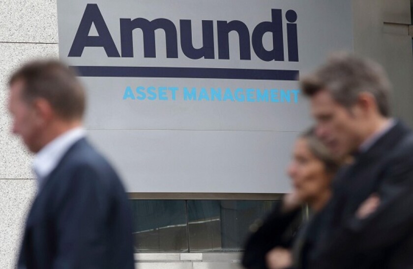 People walk near the Amundi company headquarters in Paris, France, October 7, 2015. Europe?s top asset manager Amundi promised to pay out at least 60 percent of net profit in dividends and control costs in a low-interest rate world as it outlined plans to