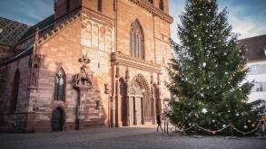 Basel, Switzerland - December 25, 2017: Architectural detail of the protestant cathedral emblem of the city decorated for Christmas