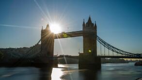 The rising sun captured in a long exposure next to Tower Bridge, London, UK.