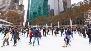 Families, people, friends ice skating at the Winter Village at Bryant Park, Manhattan, New York City.