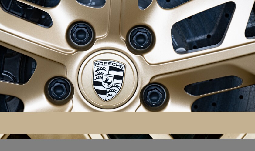 Stuttgart, Germany. 18th Mar, 2022. The Porsche logo is attached to a rim of a sports car. As the company announced when presenting its annual report, sales and operating profit reached new record levels. (to dpa: "Porsche presents record figures and welc