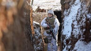 A service member of the Ukrainian armed forces walks in a trench at combat positions near the line of separation from Russian-backed rebels outside the settlement of Zaitseve in the Donetsk region, Ukraine February 5, 2022. REUTERS/Oleksandr Klymenko