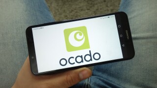 KONSKIE, POLAND - April 13, 2019: Man holding smartphone with Ocado Group plc logo